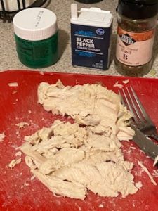Separate chicken from bone and shred.