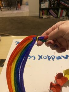 Twist the ends of the pipe cleaner rainbow before gluing to the wreath