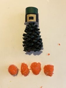 Orange pom poms for the pine cone leprechauns beard