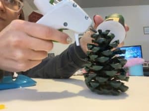 glue on the hat for St. Patrick’s Day pine cone leprechauns 