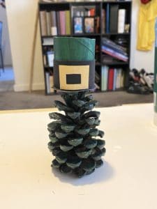 Painted green pine cone with a leprechaun hat on