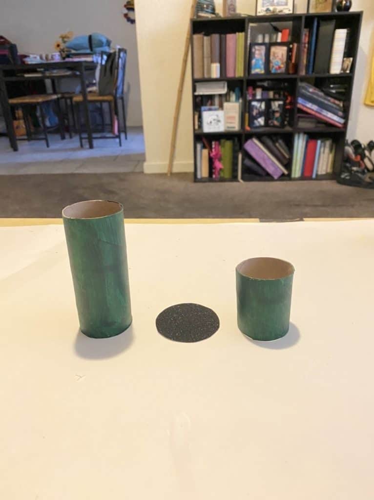 Toilet paper tube painted green is cut in half to make the Leprechaun's hat