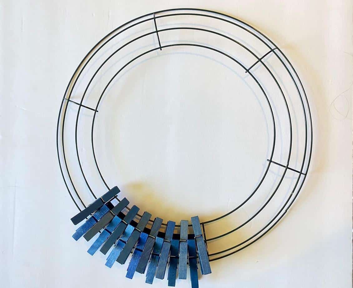 Pin the blue clothespins to the first section of the wire wreath form