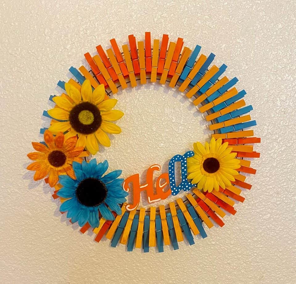 Completed project of a DIY Summer Sunflower Clothespin wreath