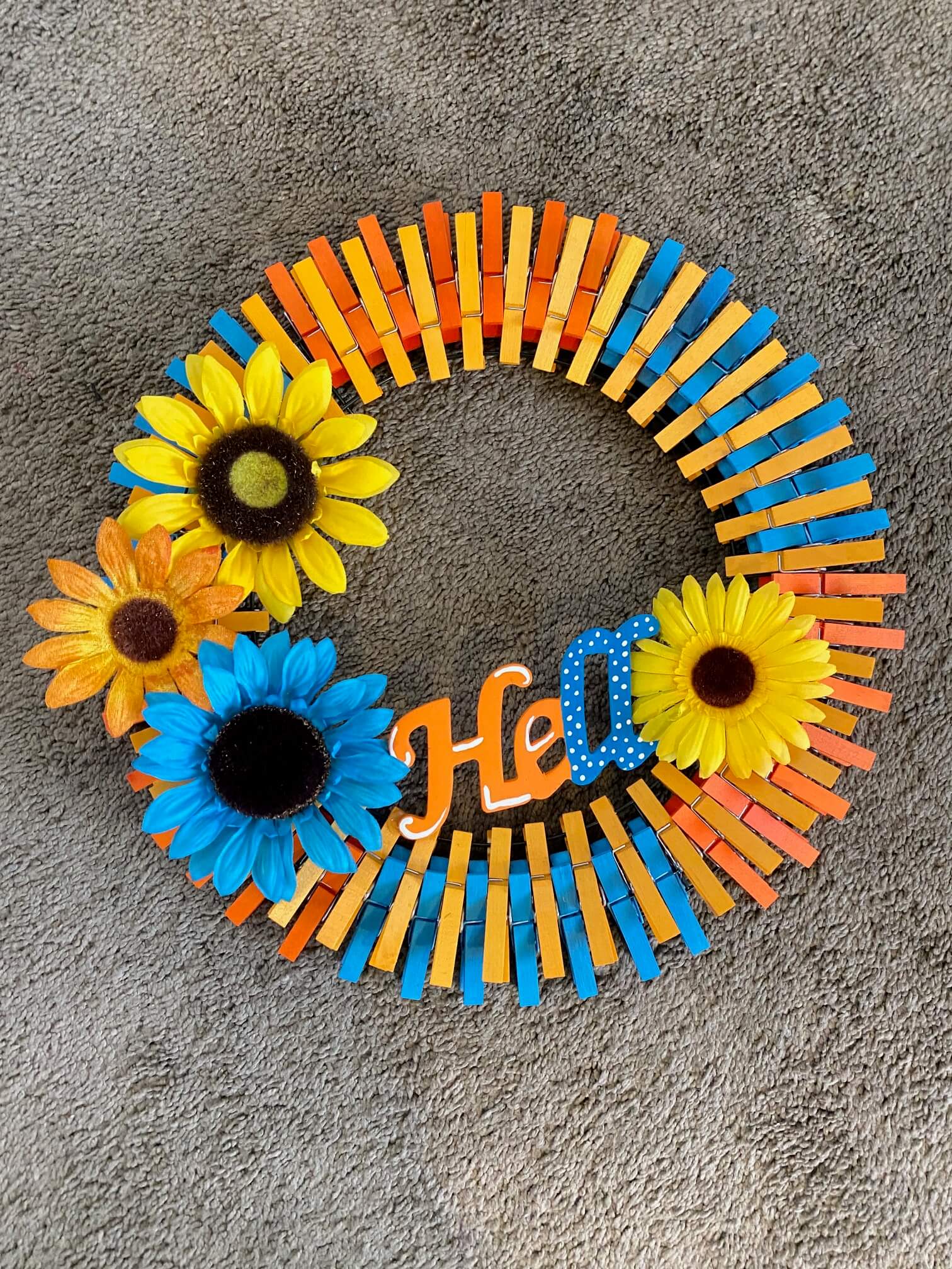 Use plenty of hot glue to secure the sign across the bottom of the wreath.  If you'd like, you can add a smaller sunflower to the 