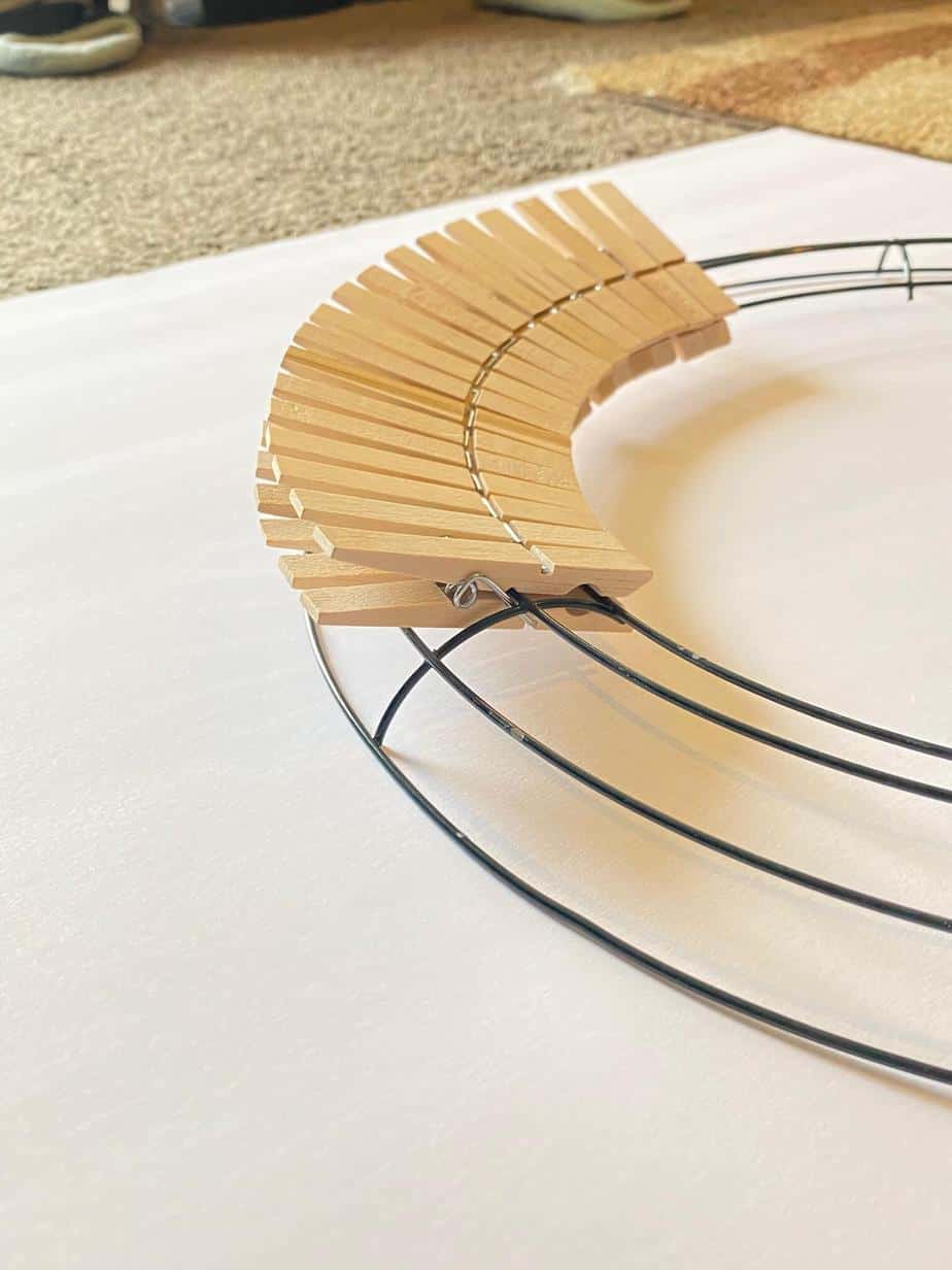 Clip the clothespins onto the innermost two wire layers of the Dollar Tree wreath form.