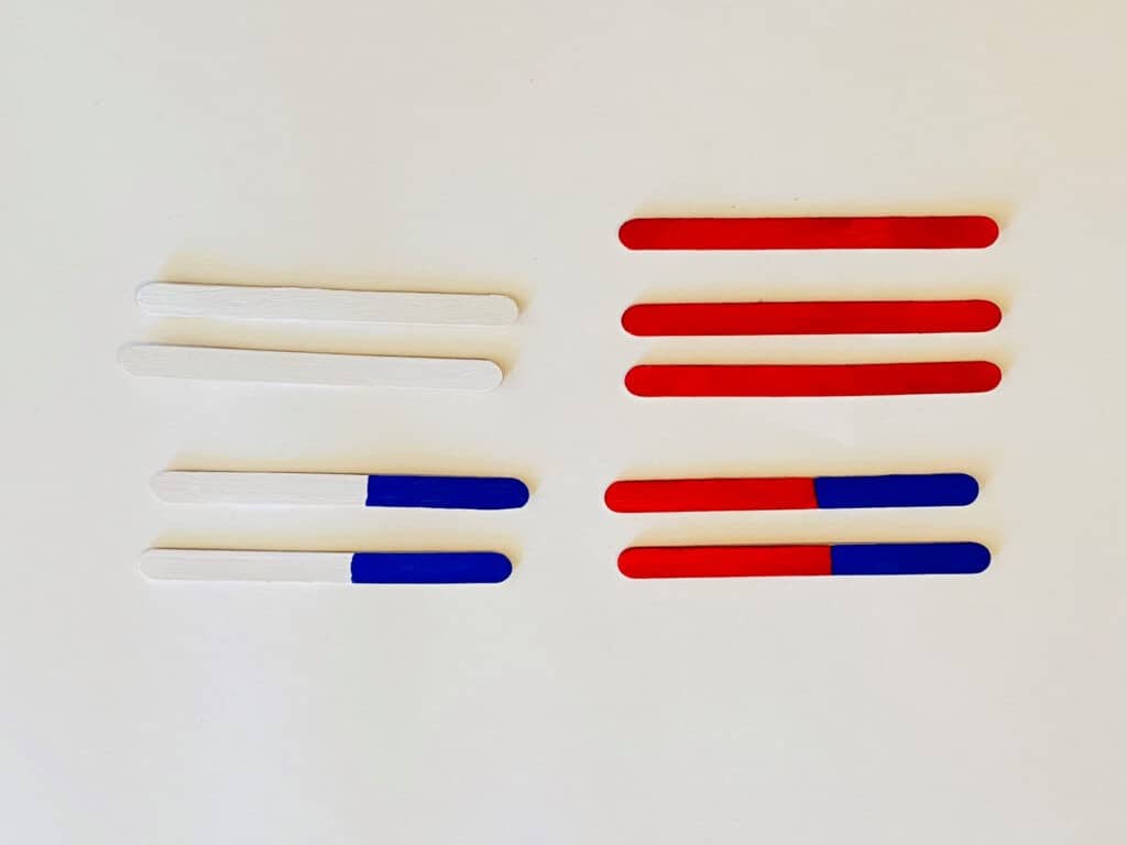 Paint the Popsicle sticks red, white, and blue like the below picture
