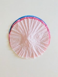 Place the red, white, and blue dyed coffee filters on top of each other in whatever order you choose.