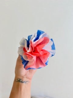 Fluff the red white and blue dyed coffee filter flowers, pull them apart a bit, and shape them how you like.
