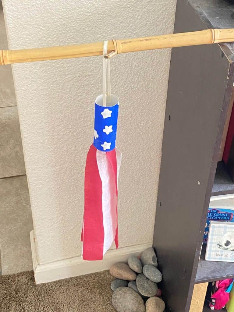 glue the string to the top of the patriotic toilet paper roll windsock to hang from