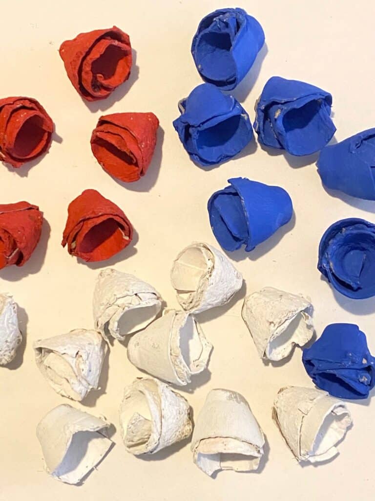 Paint the egg carton cups red, white, and blue to make the patriotic star flag wreath