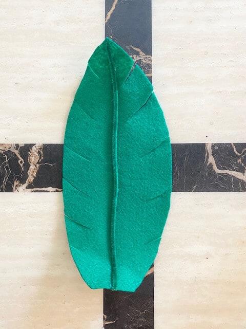 Glue a green pipe cleaner down the middle backside of each leaf
