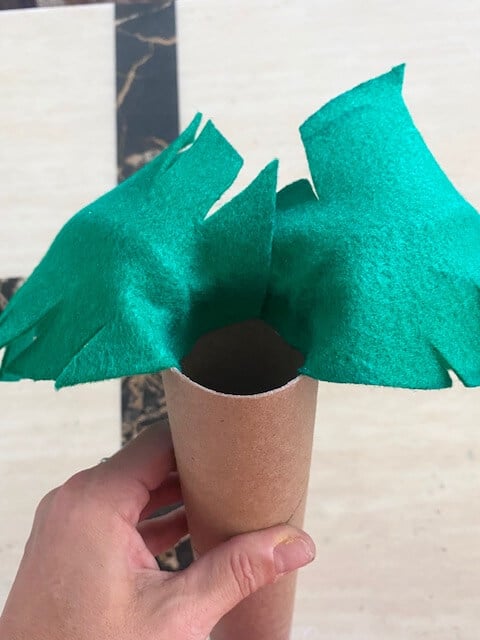 Glue the leaves to the inside top of the empty cardboard roll