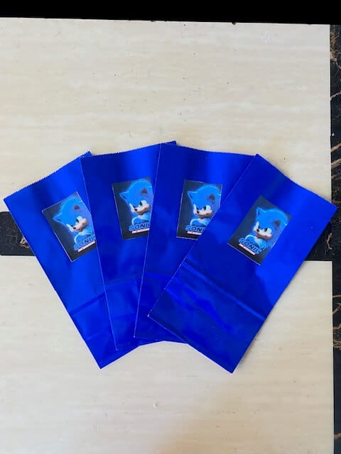 Sonic the Hedgehog party favor bags by gluing Sonic images onto regular blue favor bags. 