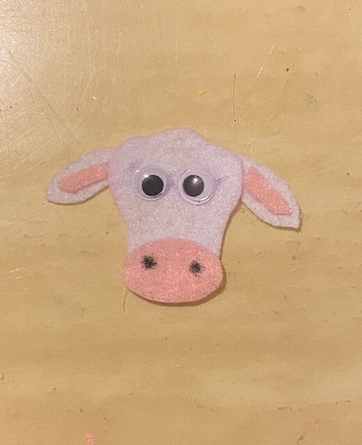 Make the cow face and ears out of felt