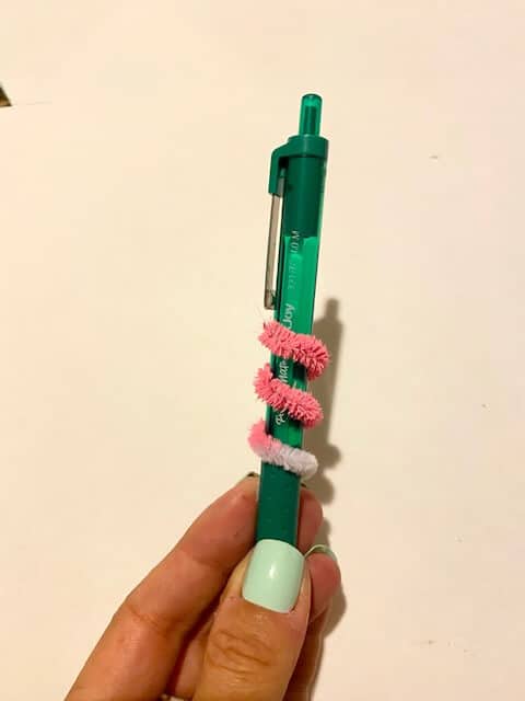 Wrap the pipe cleaner around a pen or pencil to give it the spiral shape.