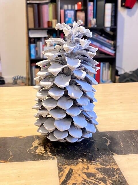 The first step to make your ghost is to paint the pine cone all white