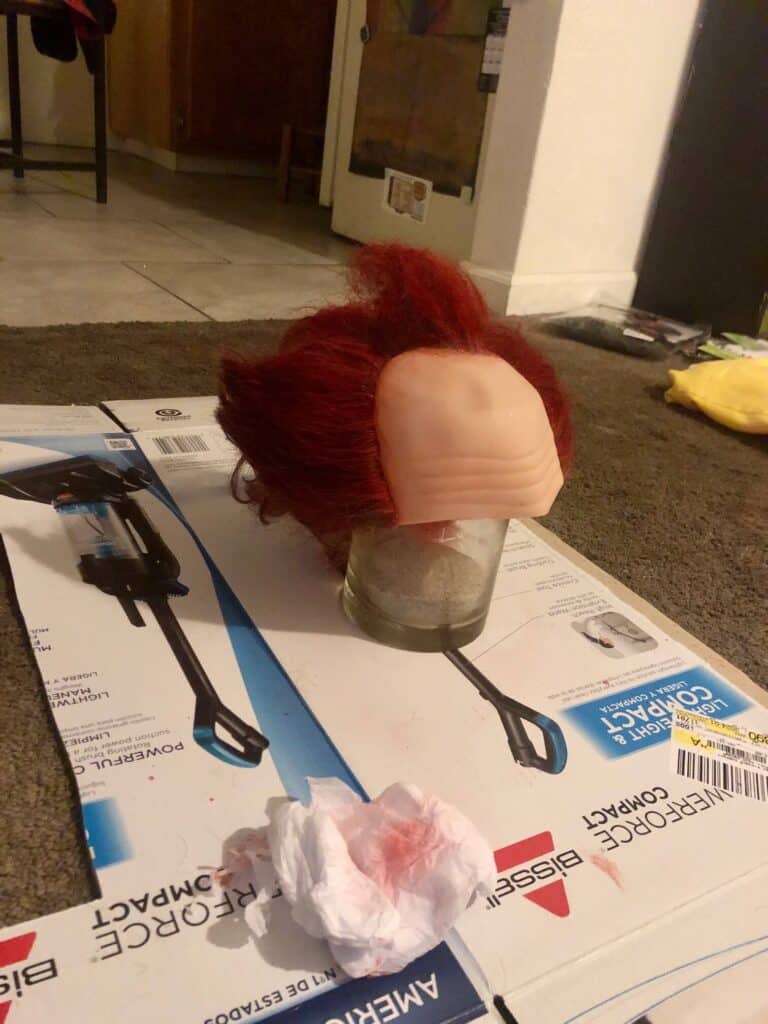 Allow the red spray hair color to fully dry on the wig hair.