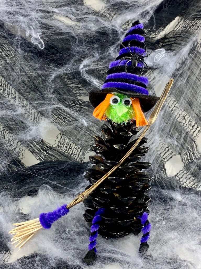 Halloween pine cone witch with hat and broom, kids DIY Halloween decorations.