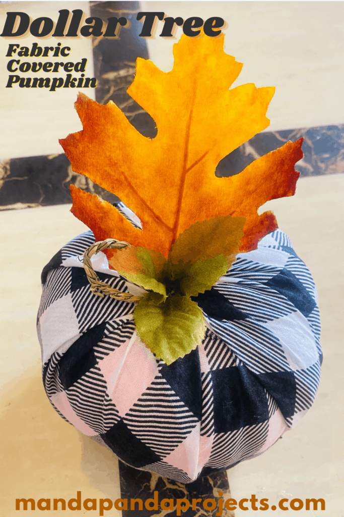 Dollar tree buffalo check (plaid) fabric covered foam pumpkin with a twine stem and a faux fall maple leaf. no glue needed.