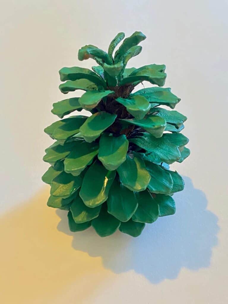 Paint the pine cone green.