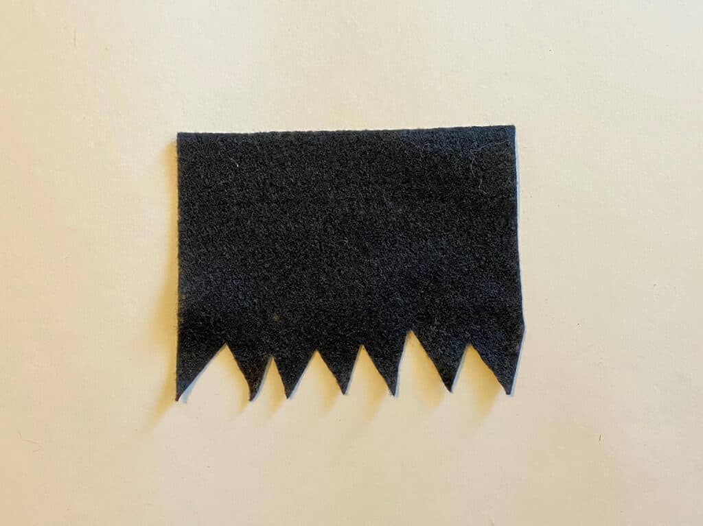 Cut the Frankenstein hair out of black felt by making the bottom zig-zag and the top straight.