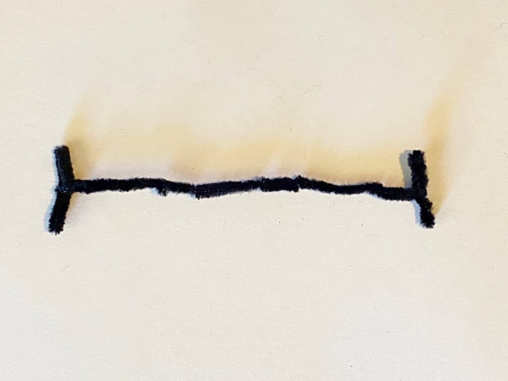 Bend the black pipe cleaner into the bolts that come out of frankensteins forehead and his "scar"