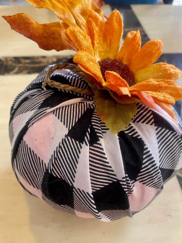 Add a sunflower to the top of the buffalo check covered pumpkin or a faux fall leaf and twine.