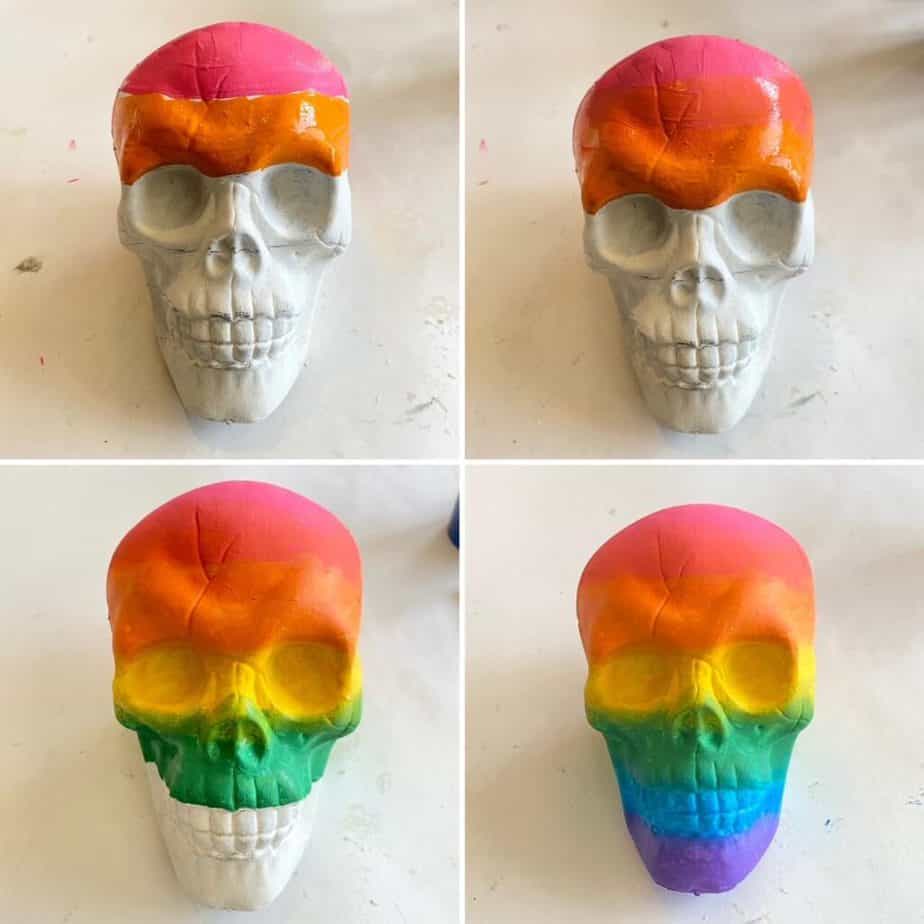 4 dollar tree skulls, each one with another color painted on in the Ombre effect. Pink, orange. yellow, green painted Dollar tree skull,