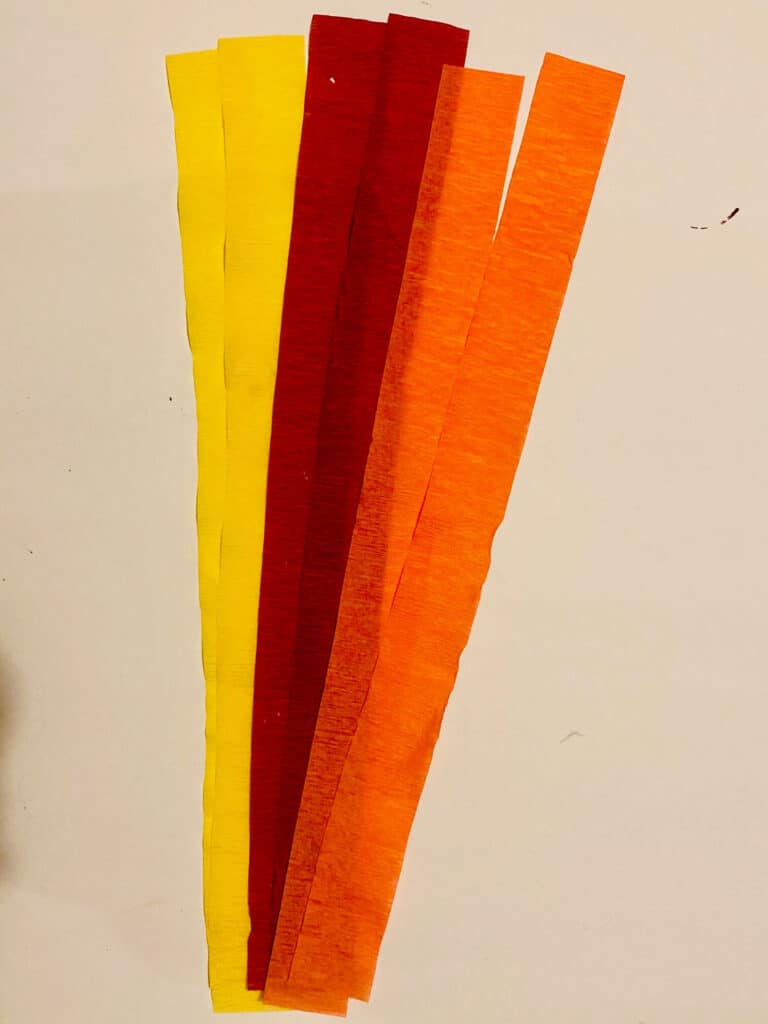 Red, orange, and yellow crepe paper streamers cut into 12 inch strips.