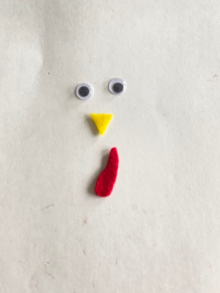 googly eyes, yellow felt beak, and a red felt turkey snood.