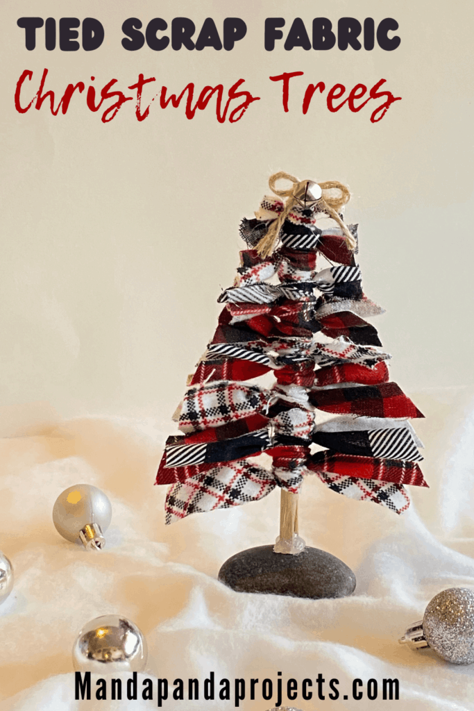 Scrap fabric christmas tree using all leftover craft supplies with a twine bow and a mini silver bell.