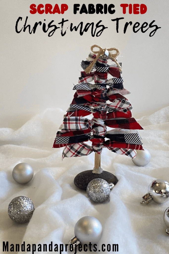 Scrap fabric christmas tree using all leftover craft supplies with a twine bow and a mini silver bell.