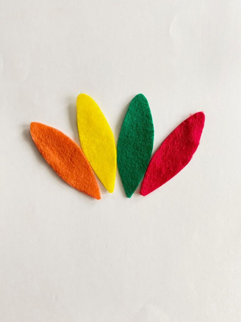 4 pieces of felt "feathers", 1 orange, 1 yellow, 1 green, 1 red.