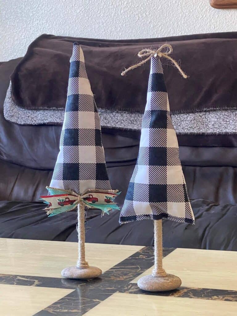 no-sew buffalo check farmhouse fabric stuffed christmas tree decorations with a wooden twine dowel and a rock base.