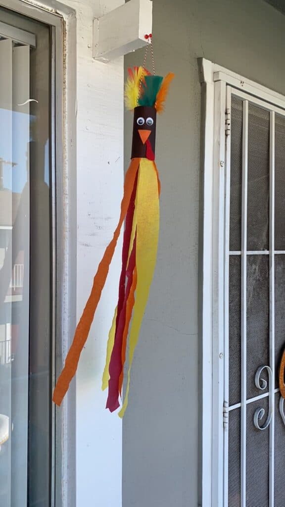 Toilet paper roll recycled craft Turkey windsock for kids, hanging outside with the streamers blowing in the wind