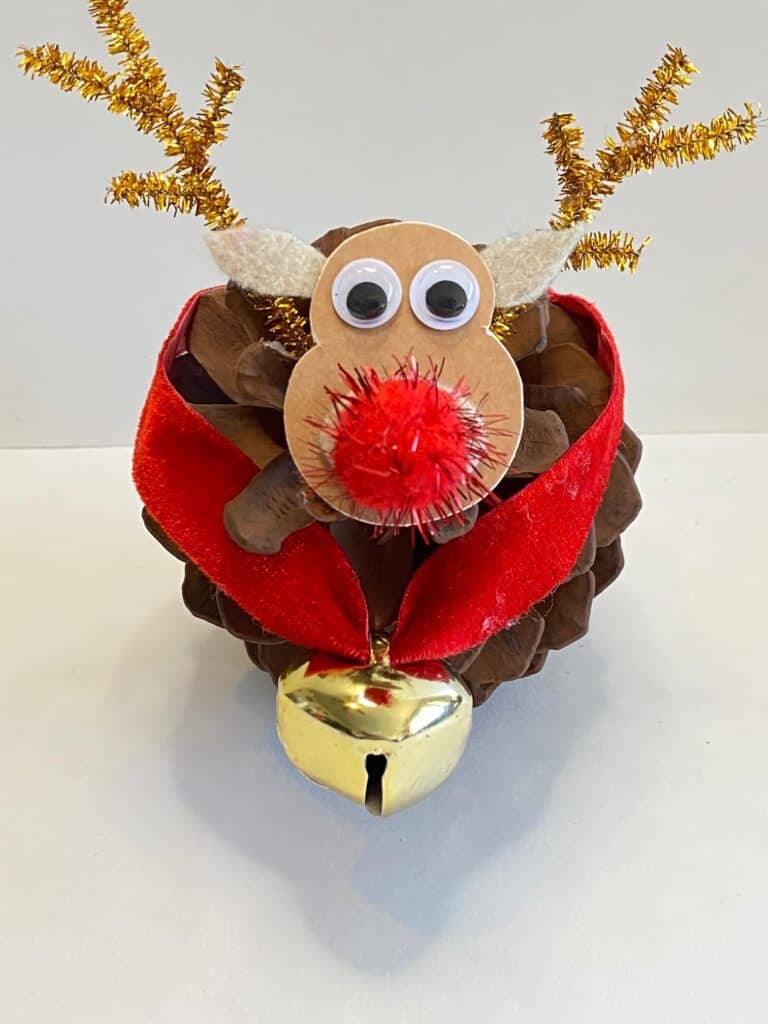 Pine cone rudolph the red nosed reindeer with golden antlers and a red collar with bell.