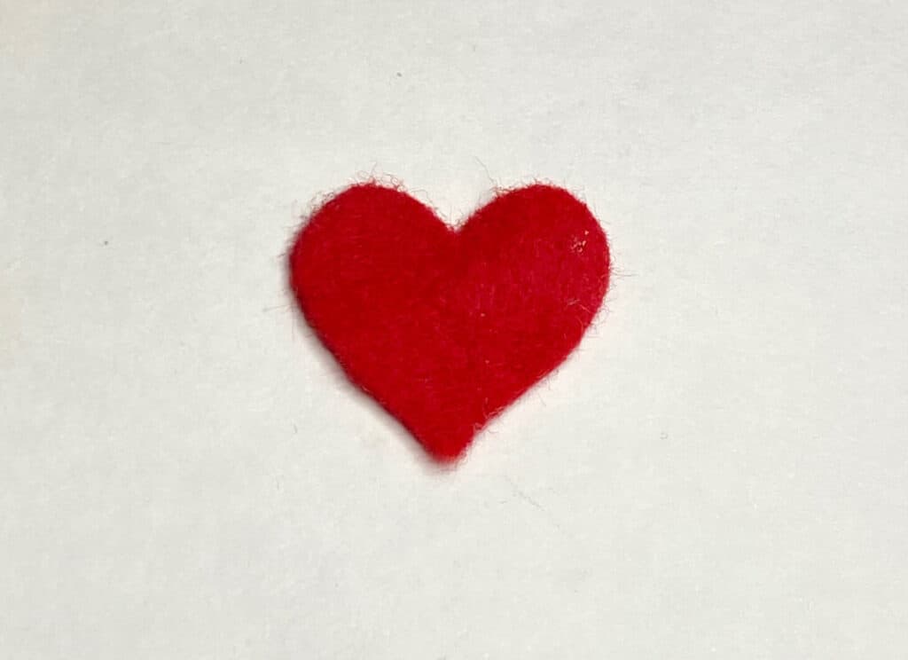 A red felt grinch heart.