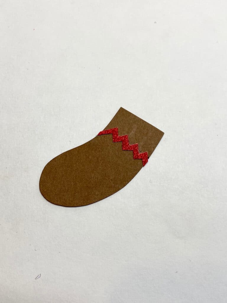 Gingerbread mans leg with red zig zag frosting decoration.
