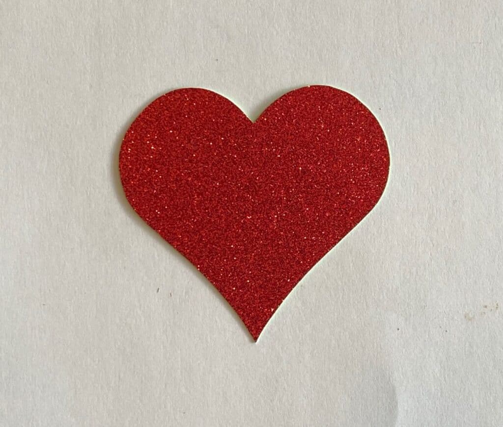 Red heart shape cut out of glitter paper for Valentines day