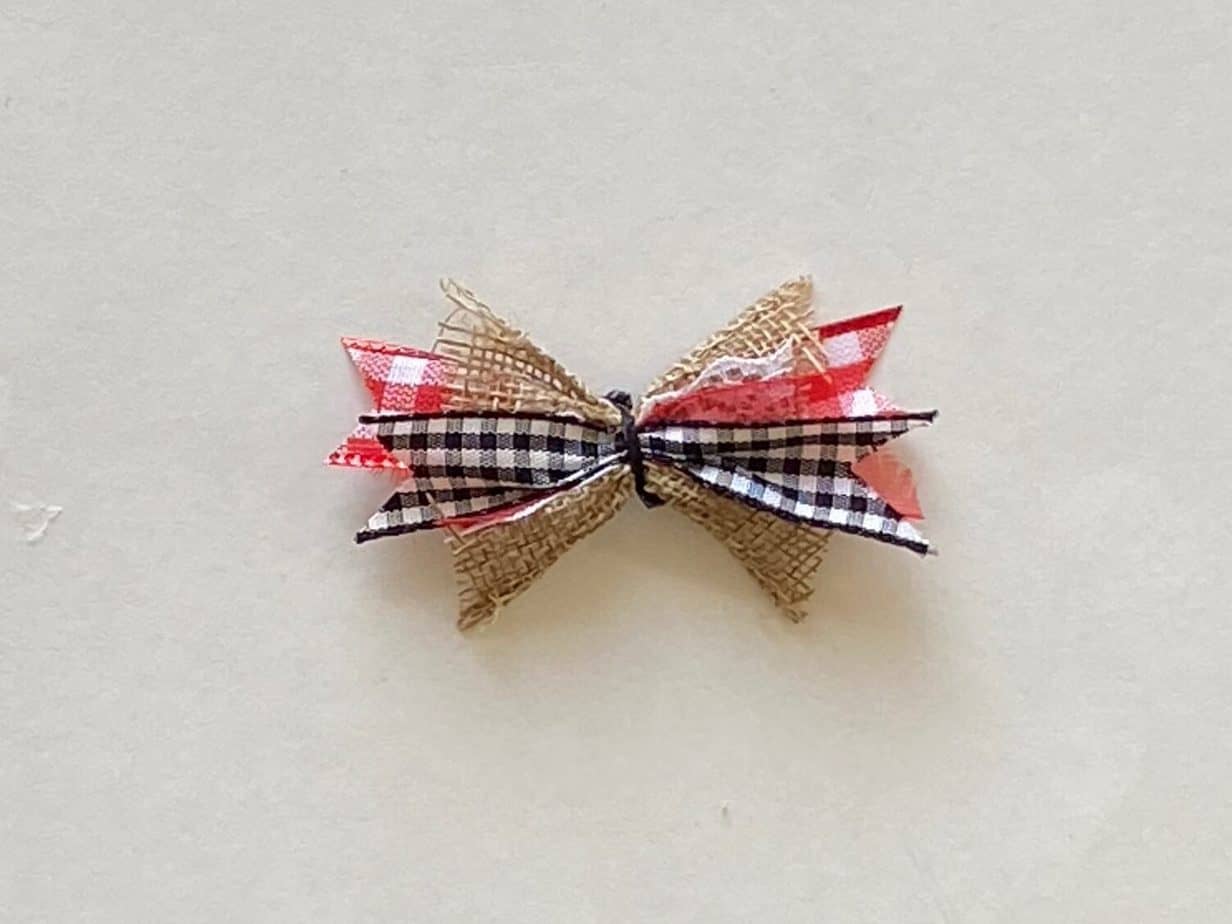 Mini scrappy bow with black and white buffalo check, red buffalo check and burlap colored ribbon pieces.
