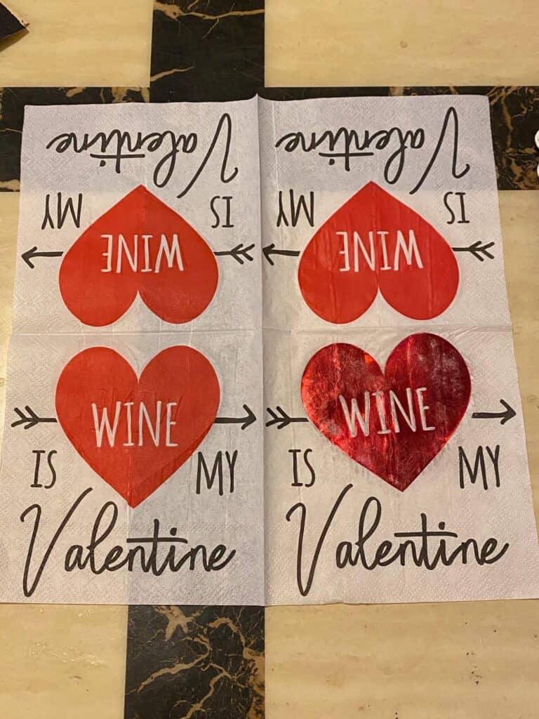 "Wine is my Valentine" napkin with a red heart opened up and unfolded to show all 4 patterned sides.