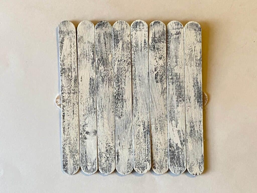 Giant popsicles stained brown and painted white wash and glued together to look like planks.