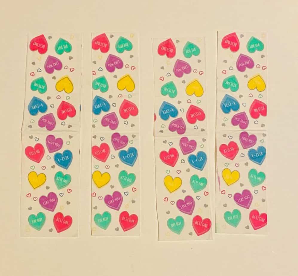 Four strips of colored conversation heart napkins, about 2 inches wide and 8 inches long.