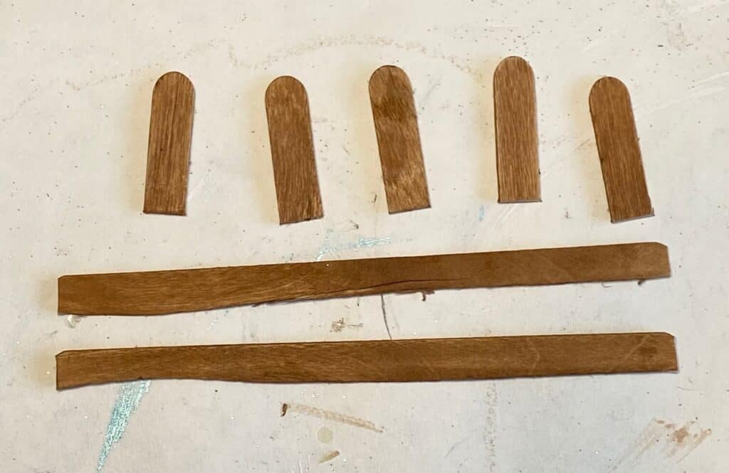 Stain the popsicle sticks brown.