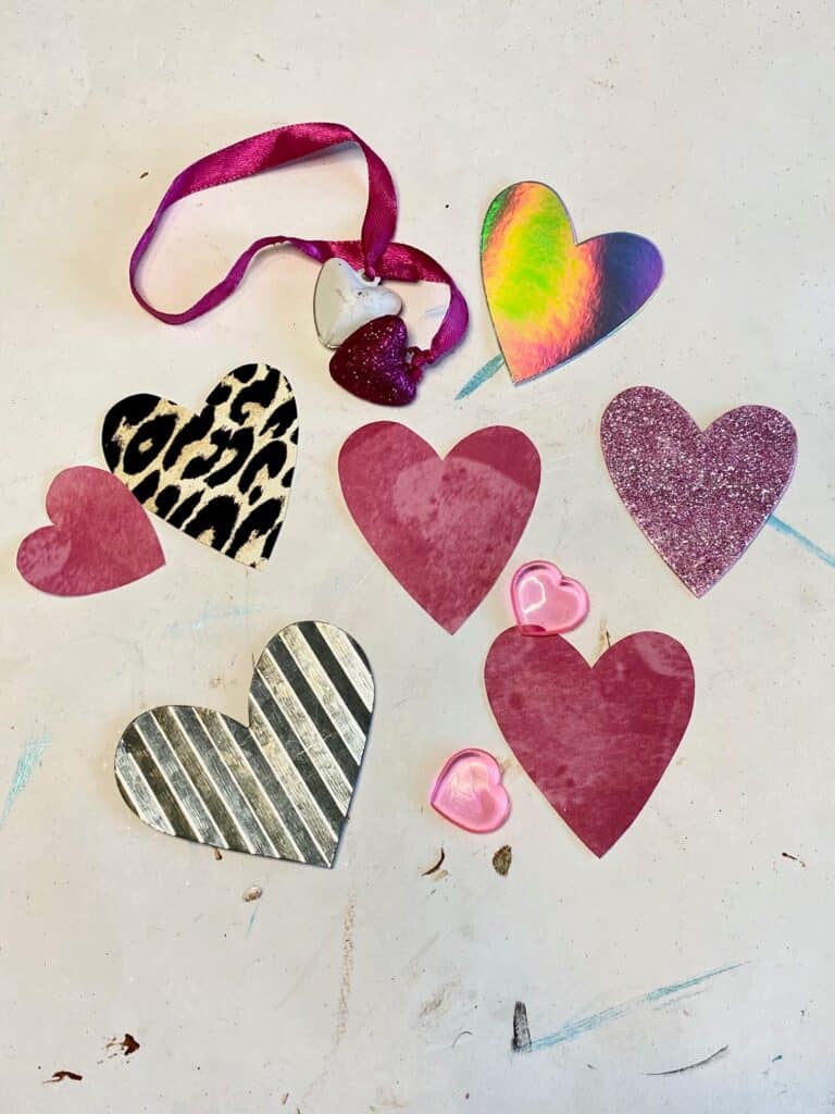 Cut a bunch of hearts out of your various colored and patterned paper, pink, leopard, black and white.