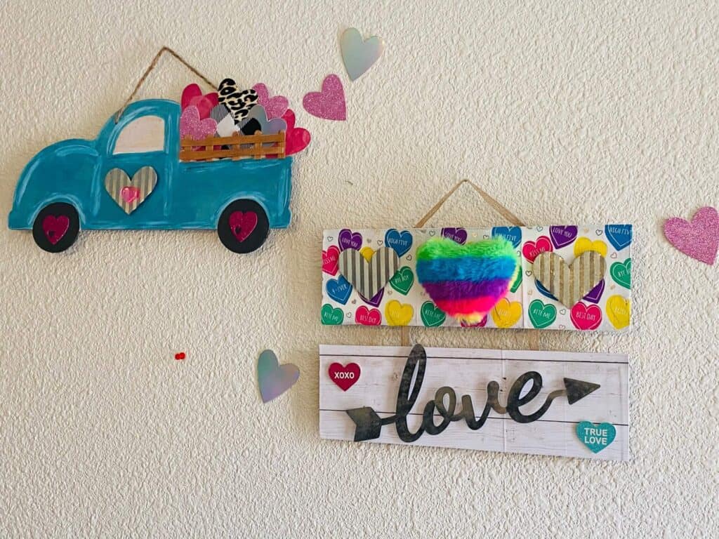 Dollar tree conversation heart "love" sign alongside a Valentine's Red Truck Makeover for DIY Valentine's Day decor.