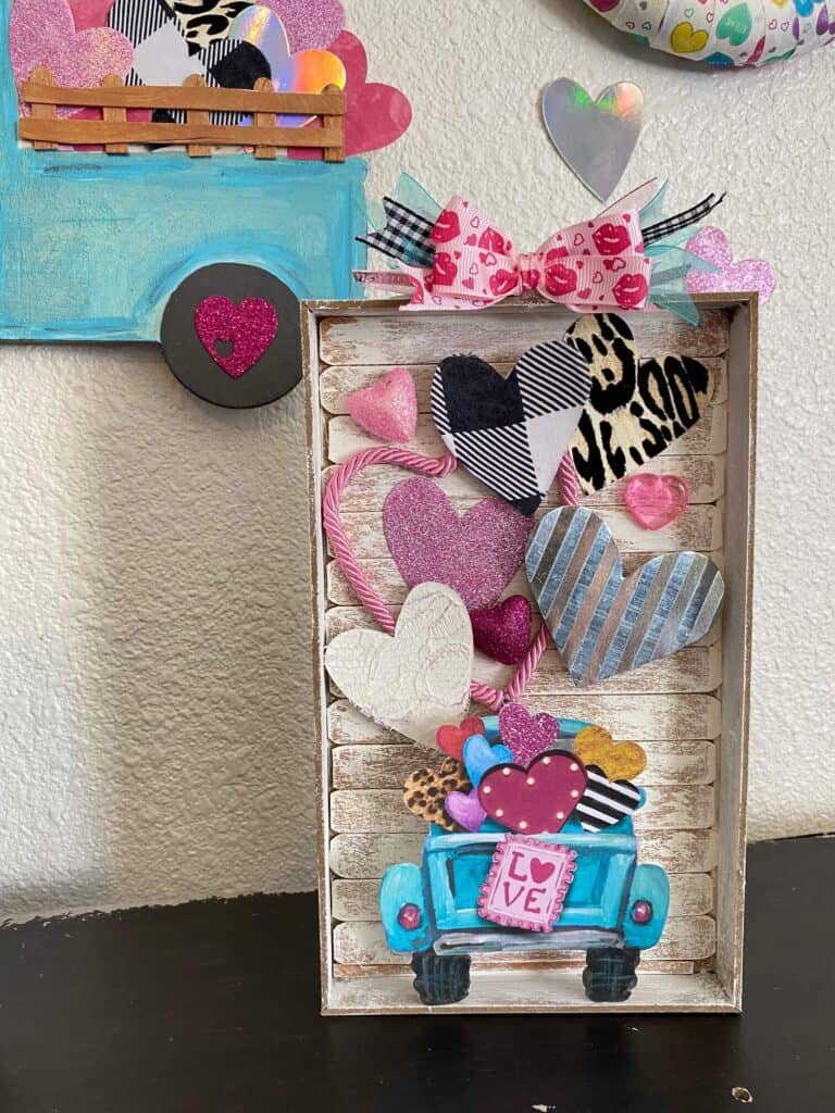 DIY Valentine truck shelf sitter with fun leopard print, buffalo check, and glitter hearts and a printable Valentine theme truck.