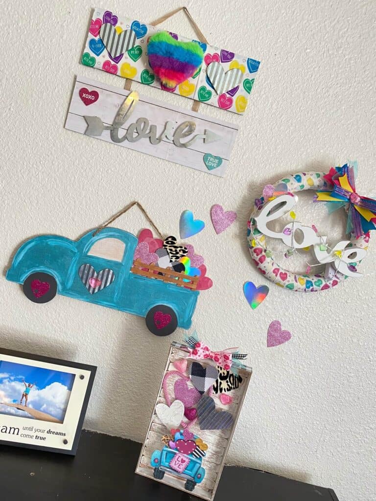 Valentine's fun and colorful themed gallery wall with DIY crafts and decor. Truck decor, wreath, and "love" sign.