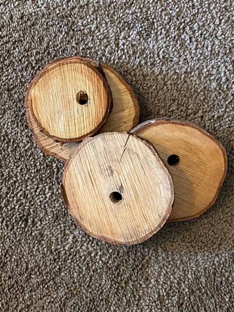 4 natural wooden rounds cut from the bottom of a tree.